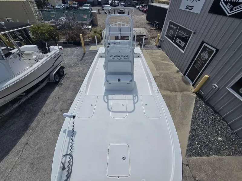 Slide: The Image of 2024 Shallow Sport X3 boat displayed outdoors, showcasing spacious deck and sleek design. - 9
