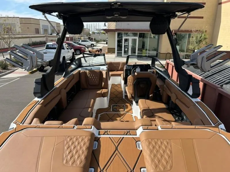 Slide: The Image of 2025 Malibu M230 boat interior with luxurious brown leather seating and modern design. - 10