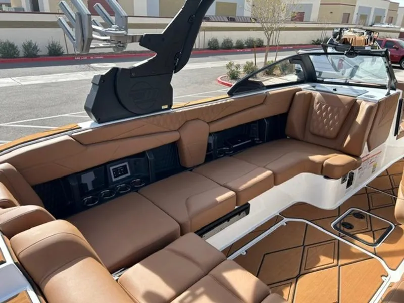 Slide: The Image of Luxurious interior of 2025 Malibu M230 boat with tan leather seating. - 14