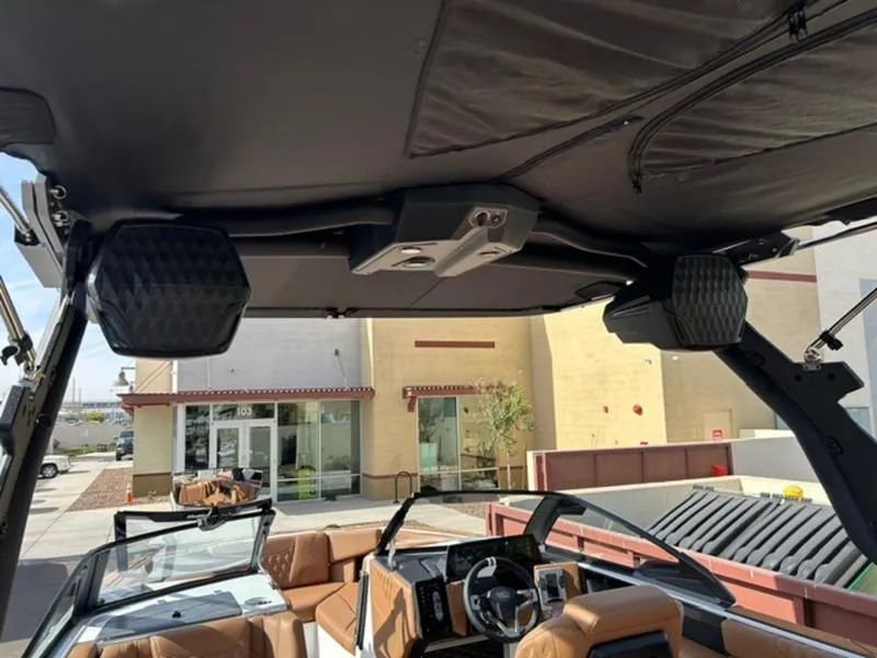 Slide: The Image of 2025 Malibu M230 boat interior with premium audio system and luxurious seating. - 15