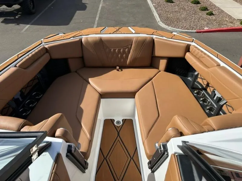 Slide: The Image of 2025 Malibu M230 boat interior with luxurious tan leather seating. - 17