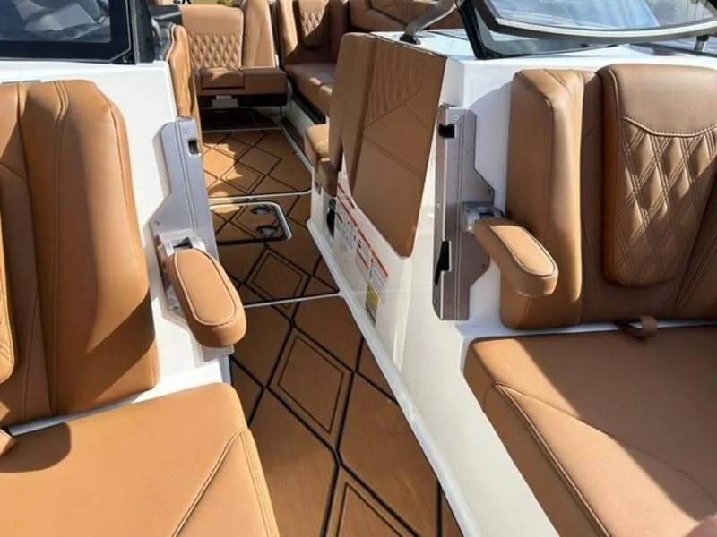 Slide: The Image of 2025 Malibu M230 boat interior with tan leather seats and geometric floor design. - 18