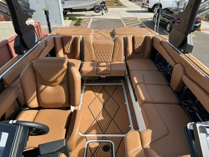 Slide: The Image of Luxurious interior of 2025 Malibu M230 boat with tan leather seating. - 19