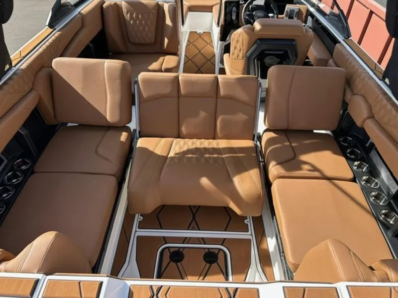 Slide: The Image of 2025 Malibu M230 boat interior with luxurious tan leather seating and modern design. - 23