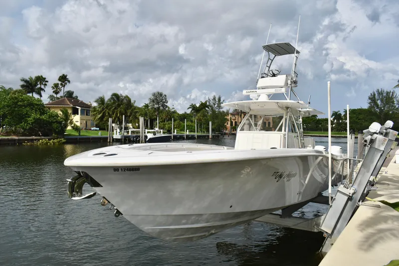 The Image of 2013 Invincible 42 Open Fisherman boat docked by a scenic waterfront. - 1