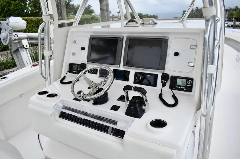 Slide: The Image of Control panel of 2013 Invincible 42 Open Fisherman boat with dual screens and steering wheel. - 13
