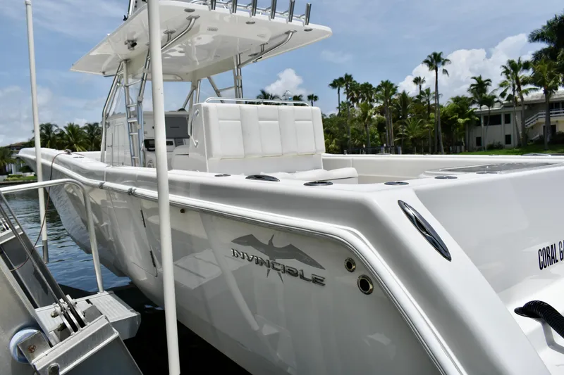 Slide: The Image of 2013 Invincible 42 Open Fisherman boat docked, showcasing sleek design and spacious deck. - 2