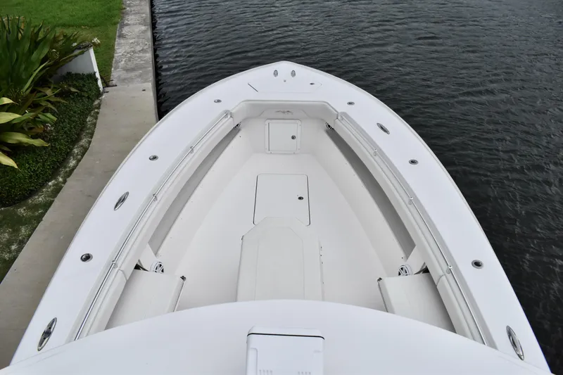 Slide: The Image of 2013 Invincible 42 Open Fisherman boat, top view, docked by water. - 23