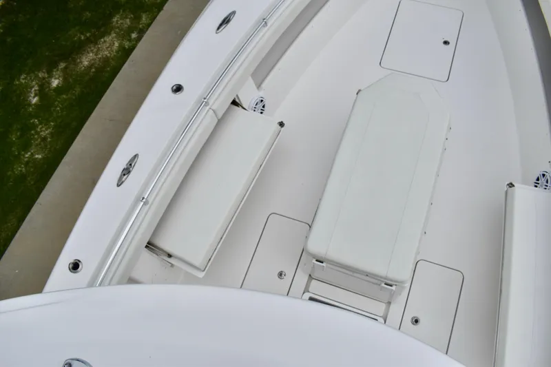 Slide: The Image of 2013 Invincible 42 Open Fisherman boat deck, featuring seating and storage compartments. - 24