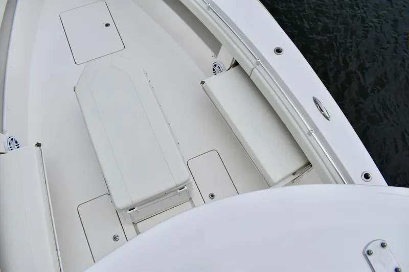 Slide: The Image of 2013 Invincible 42 Open Fisherman boat deck with seating and storage compartments. - 25