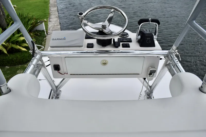 Slide: The Image of Control console of 2013 Invincible 42 Open Fisherman boat with steering wheel and Garmin equipment. - 26