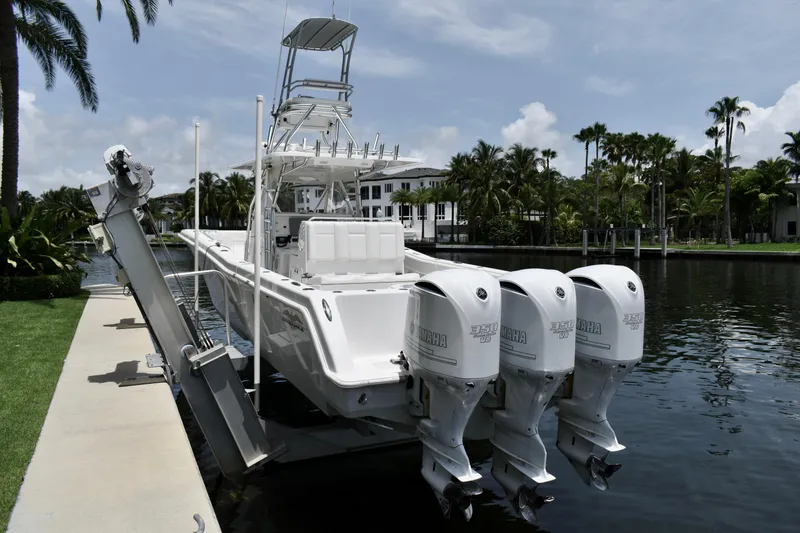 Slide: The Image of 2013 Invincible 42 Open Fisherman boat docked with triple outboard engines. - 3