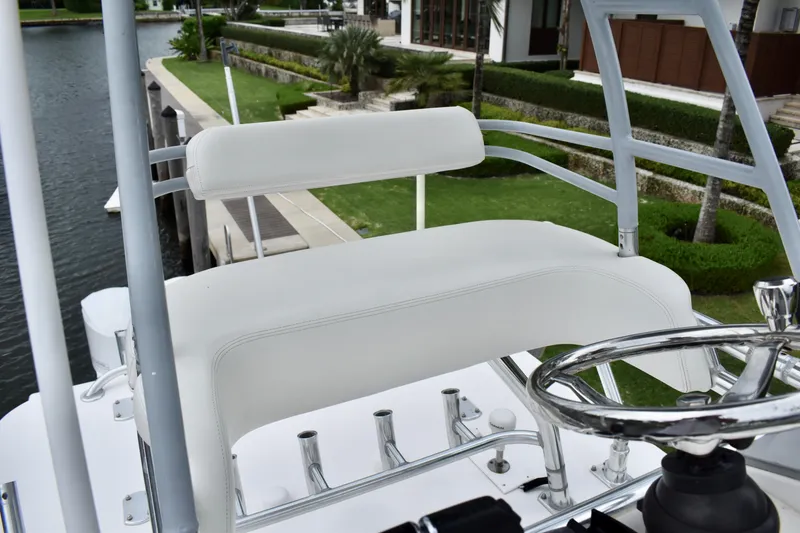 Slide: The Image of 2013 Invincible 42 Open Fisherman helm seat with steering wheel, dockside view. - 30