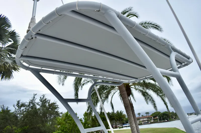 Slide: The Image of 2013 Invincible 42 Open Fisherman boat canopy with palm trees in the background. - 31