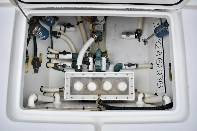 Slide: The Image of 2013 Invincible 42 Open Fisherman boat plumbing system with pipes and filters. - 32