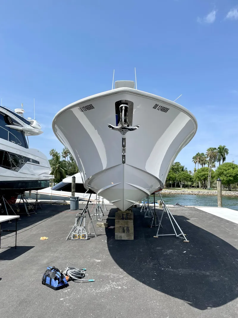 Slide: The Image of 2013 Invincible 42 Open Fisherman boat on dry dock, clear sky background. - 4