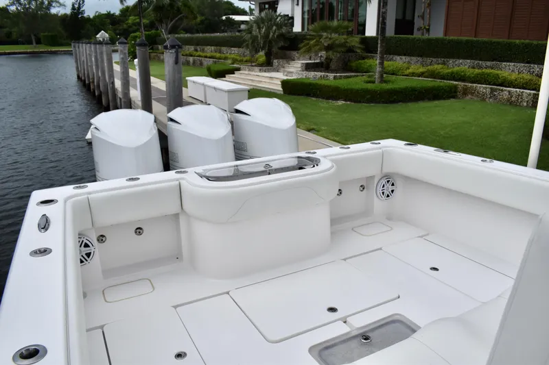 Slide: The Image of 2013 Invincible 42 Open Fisherman boat docked by a waterfront property. - 9