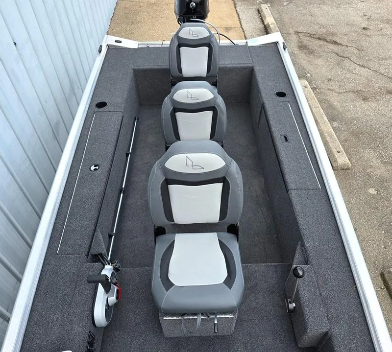 Slide: The Image of 2025 Lowe Skorpion Stick Steer boat interior with three seats, livewell and rod storage. - 7