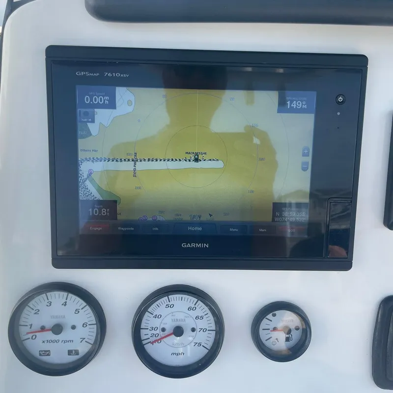 Slide: The Image of Garmin GPS display and gauges on 2015 NauticStar 2200XS Offshore boat dashboard. - 11