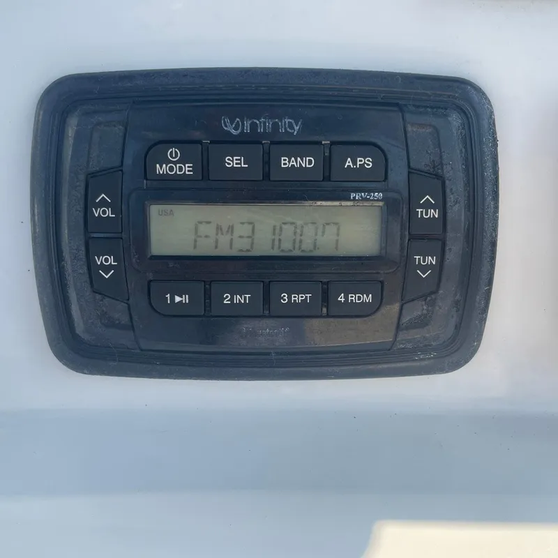 Slide: The Image of Infinity marine radio display on 2015 NauticStar 2200XS Offshore boat. - 13