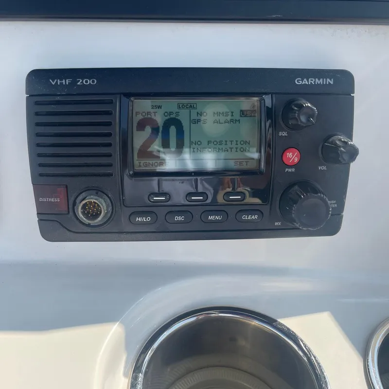 Slide: The Image of Garmin VHF 200 radio on 2015 NauticStar 2200XS Offshore boat dashboard. - 15