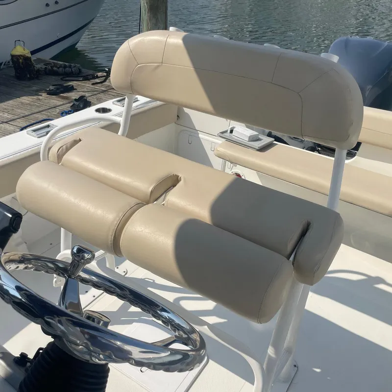 Slide: The Image of 2015 NauticStar 2200XS Offshore boat seat and steering wheel. - 17