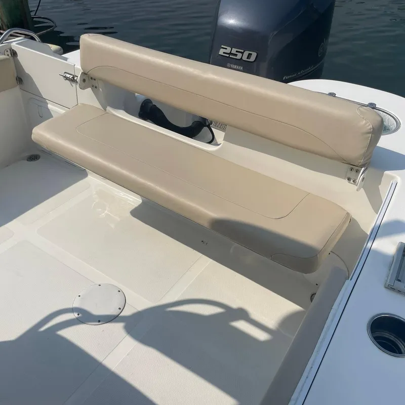 Slide: The Image of 2015 NauticStar 2200XS Offshore boat with beige seating and 250 horsepower engine. - 20