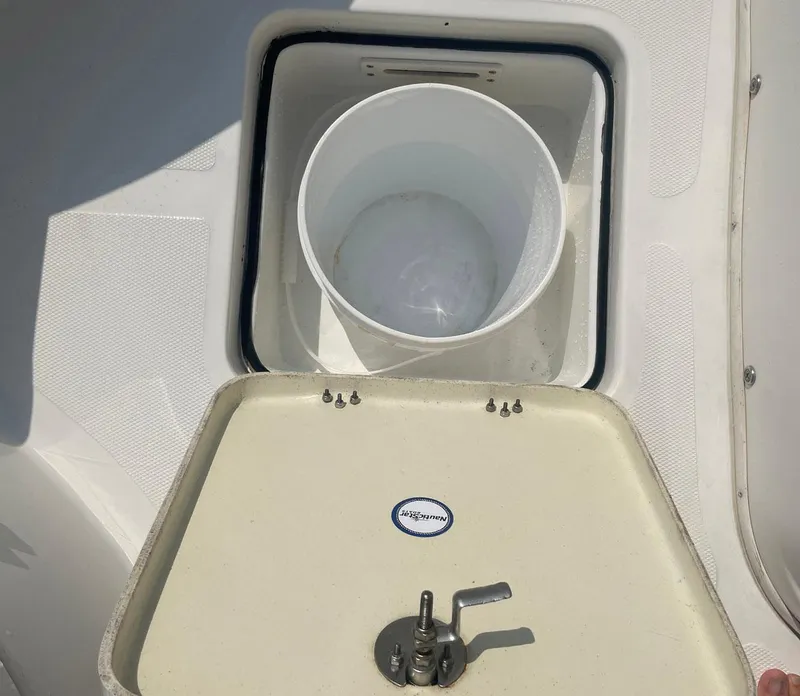 Slide: The Image of Open storage compartment on 2015 NauticStar 2200XS Offshore boat. - 22