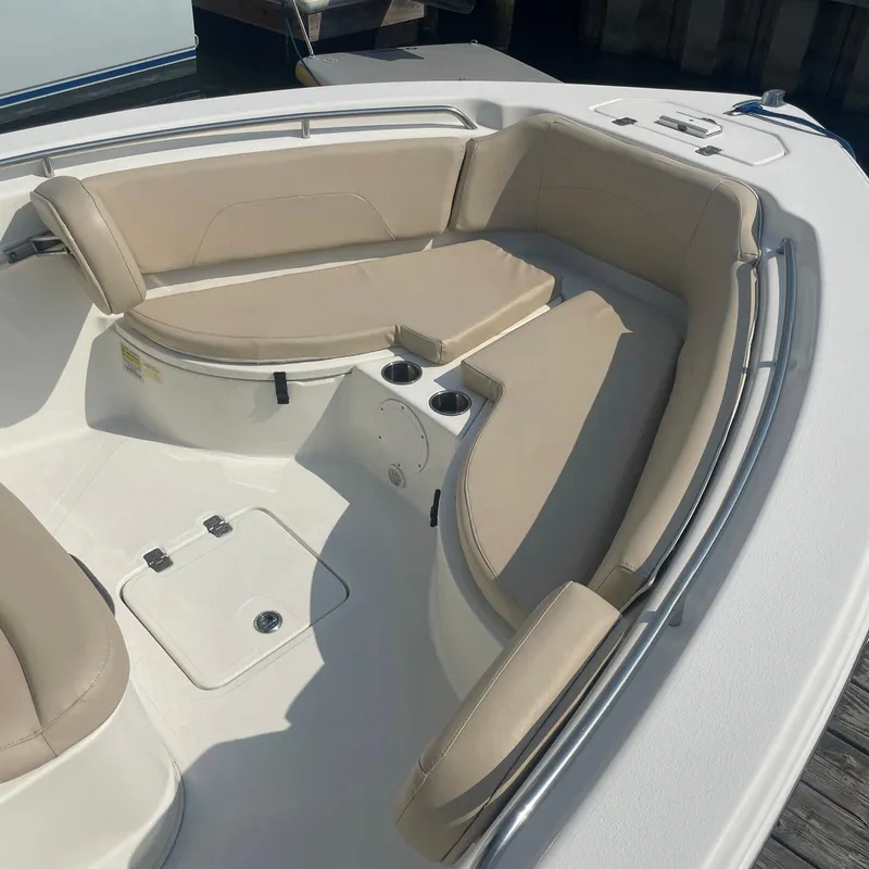 Slide: The Image of 2015 NauticStar 2200XS Offshore boat interior with beige seating and cup holders. - 4