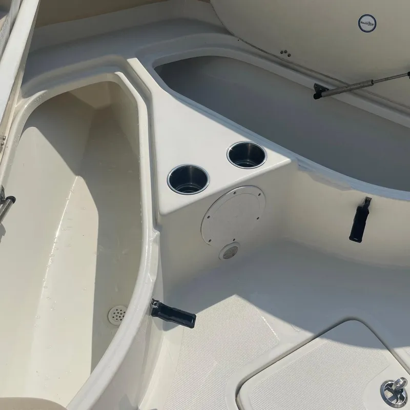 Slide: The Image of 2015 NauticStar 2200XS Offshore boat interior with cup holders and storage compartments. - 5