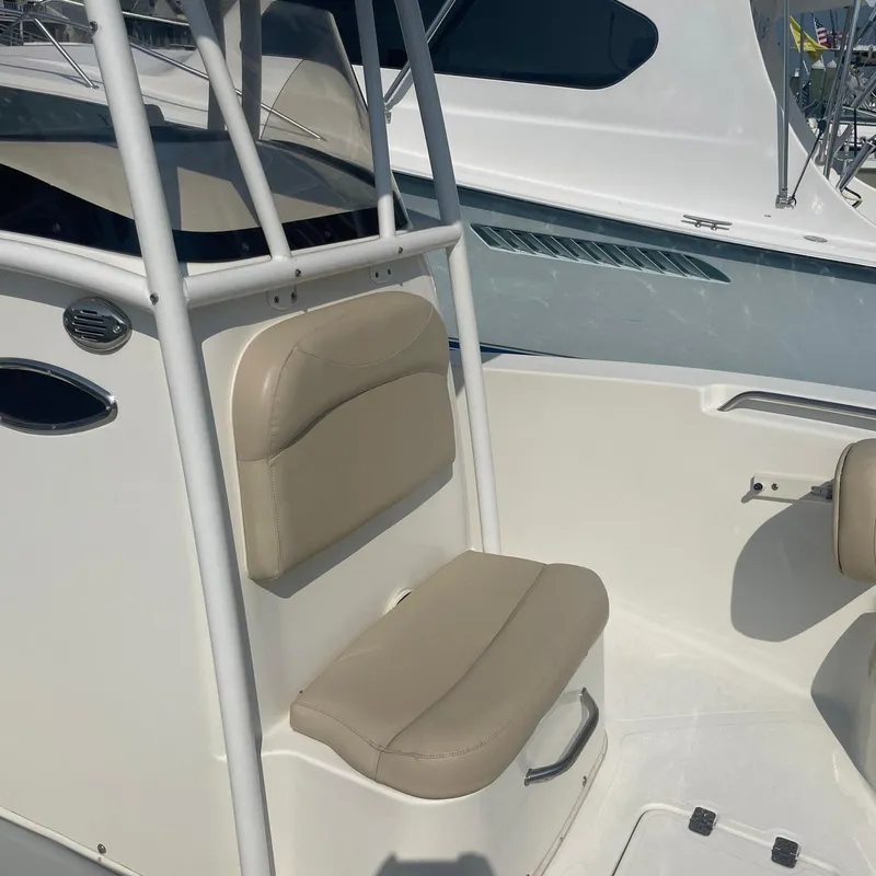 Slide: The Image of 2015 NauticStar 2200XS Offshore boat interior with beige seating and white console. - 6