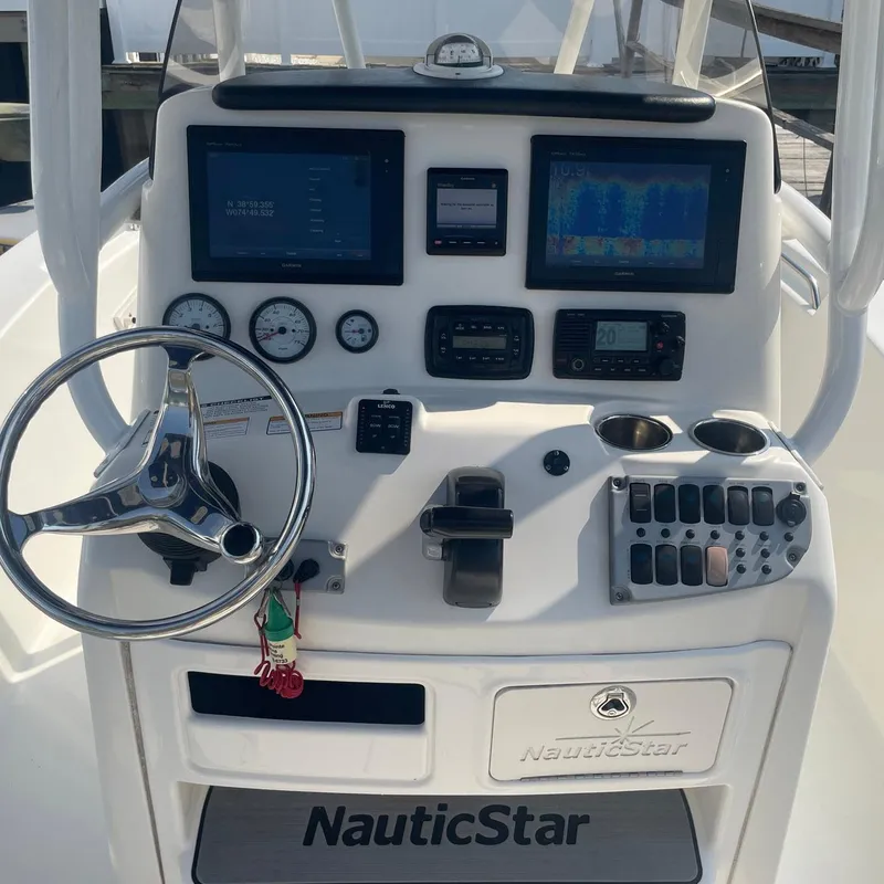 Slide: The Image of Control panel of a 2015 NauticStar 2200XS Offshore boat with steering wheel and gauges. - 9