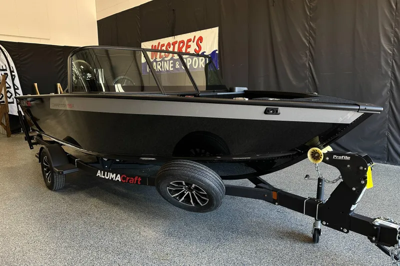 Slide: The Image of 2026 Alumacraft Competitor 185X Sport boat interior with steering wheel and seats. - 10