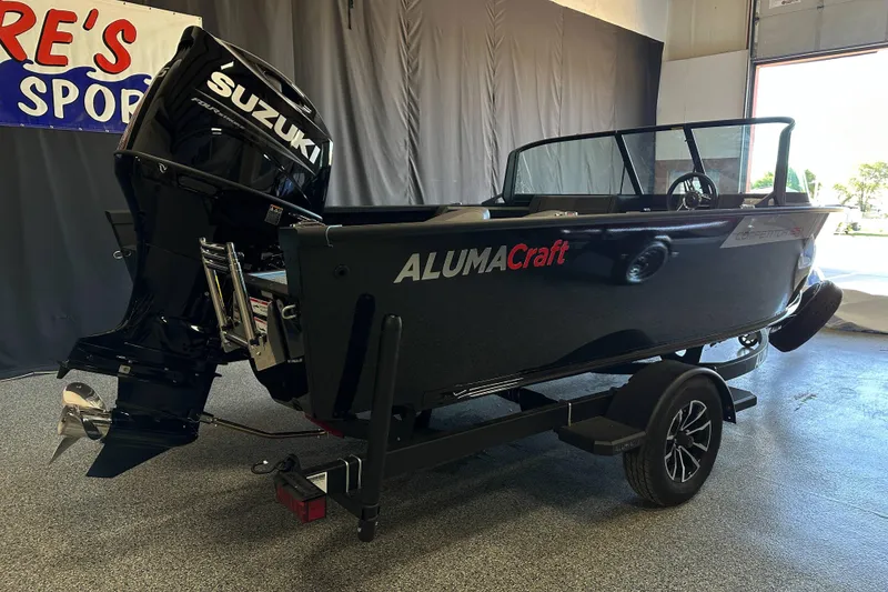 Slide: The Image of 2026 Alumacraft Competitor 185X Sport dashboard with steering wheel and Garmin navigation system. - 11