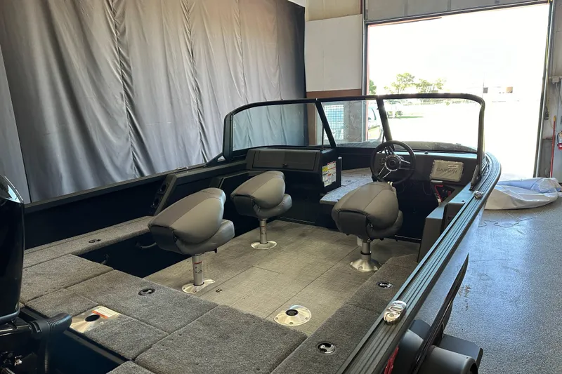 Slide: The Image of 2026 Alumacraft Competitor 185X Sport interior with seating and storage compartments. - 12