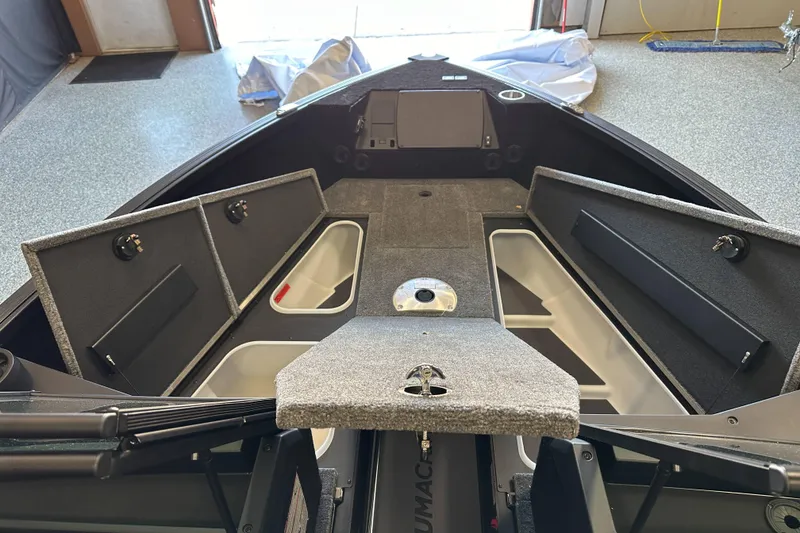 Slide: The Image of 2026 Alumacraft Competitor 185X Sport storage compartments with secure latches and sleek interior design. - 14
