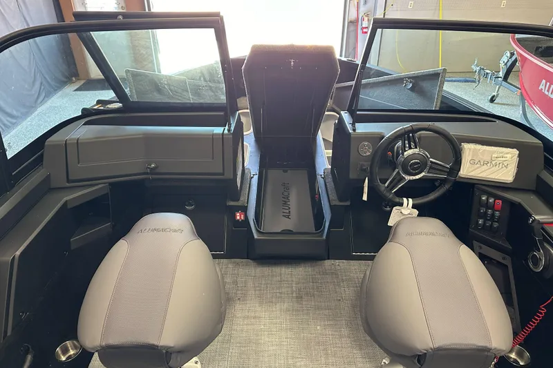 Slide: The Image of 2026 Alumacraft Competitor 185X Sport interior with storage compartments and seating. - 15