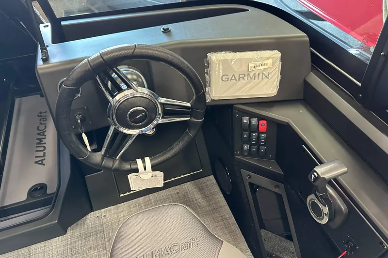 Slide: The Image of 2026 Alumacraft Competitor 185X Sport interior with storage compartment and seating. - 16