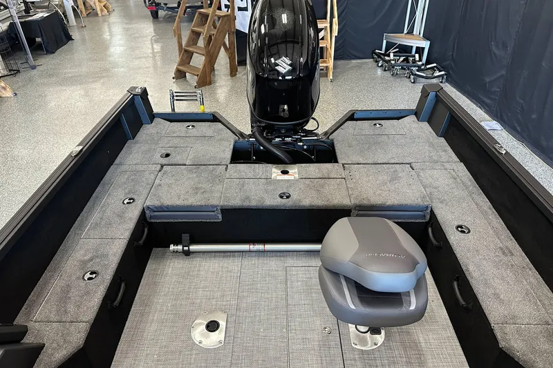 Slide: The Image of Interior view of 2026 Alumacraft Competitor 185X Sport boat, featuring spacious carpeted deck. - 17