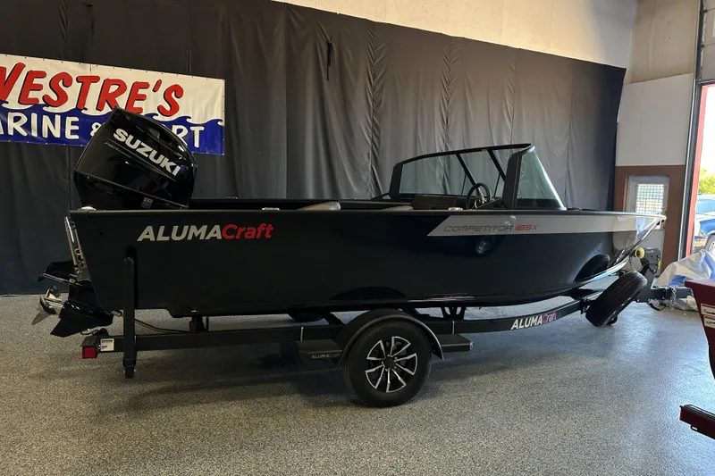 Slide: The Image of 2026 Alumacraft Competitor 185X Sport boat with Suzuki engine on trailer in showroom. - 5