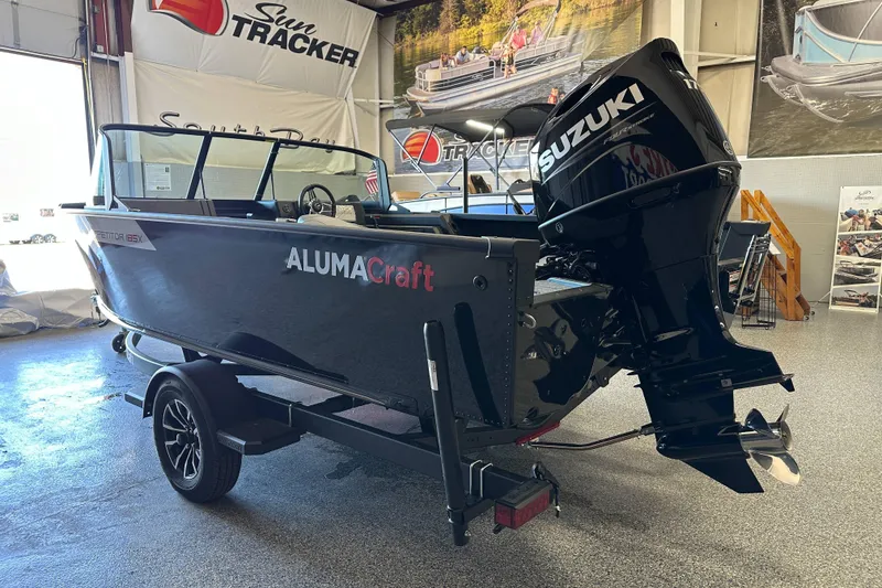 Slide: The Image of 2026 Alumacraft Competitor 185X Sport boat interior with seating and steering wheel. - 7