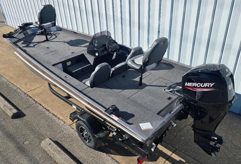 Slide: The Image of 2025 Lowe 1860 Legacy boat with Mercury engine, parked on a trailer. - 2