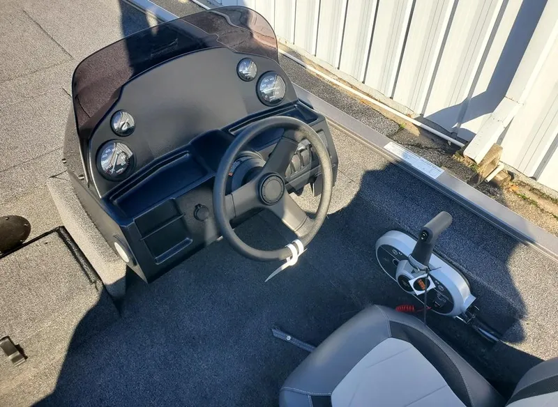 Slide: The Image of 2025 Lowe 1860 Legacy boat cockpit with steering wheel and controls. - 3