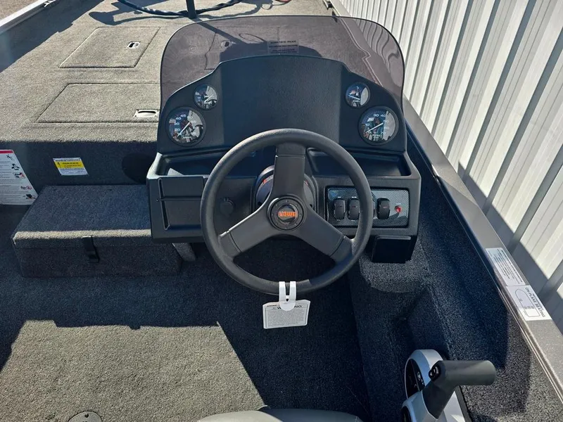 Slide: The Image of 2025 Lowe 1860 Legacy boat dashboard with steering wheel and gauges. - 8