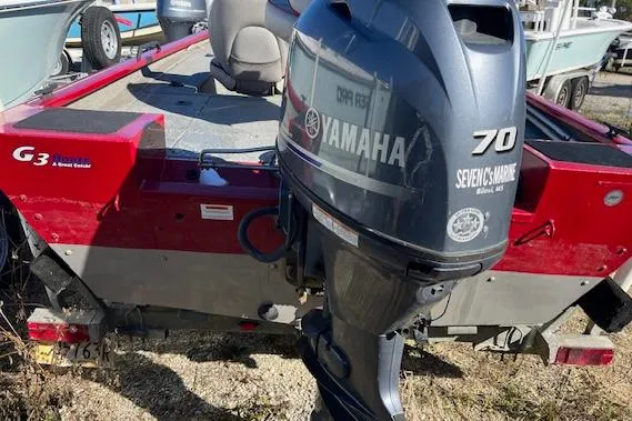 Slide: The Image of 2014 G3 176 EAGLE red fishing boat on trailer, parked outdoors. - 1
