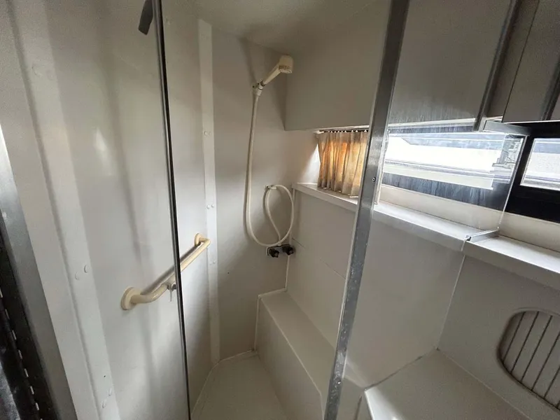 Slide: The Image of Shower area in 1995 Carver 370 Aft Cabin boat, featuring a handheld showerhead. - 14