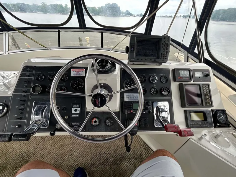 Slide: The Image of 1995 Carver 370 Aft Cabin helm with steering wheel and navigation instruments. - 15