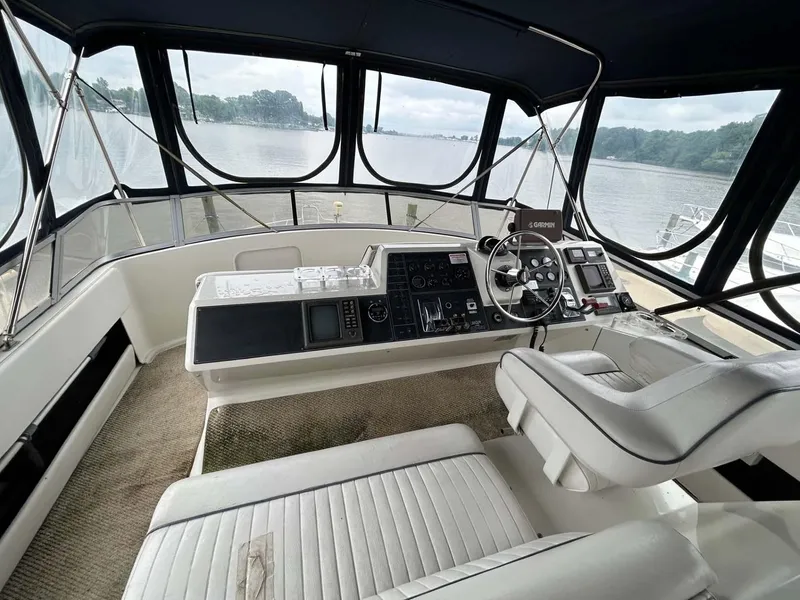 Slide: The Image of 1995 Carver 370 Aft Cabin helm with panoramic river view and modern controls. - 18