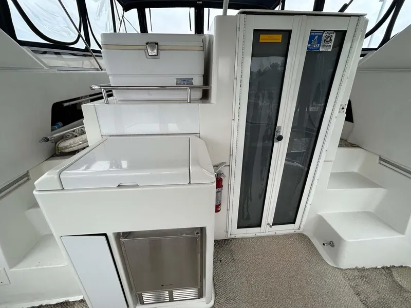 Slide: The Image of 1995 Carver 370 Aft Cabin interior with storage, steps, and glass doors. - 22