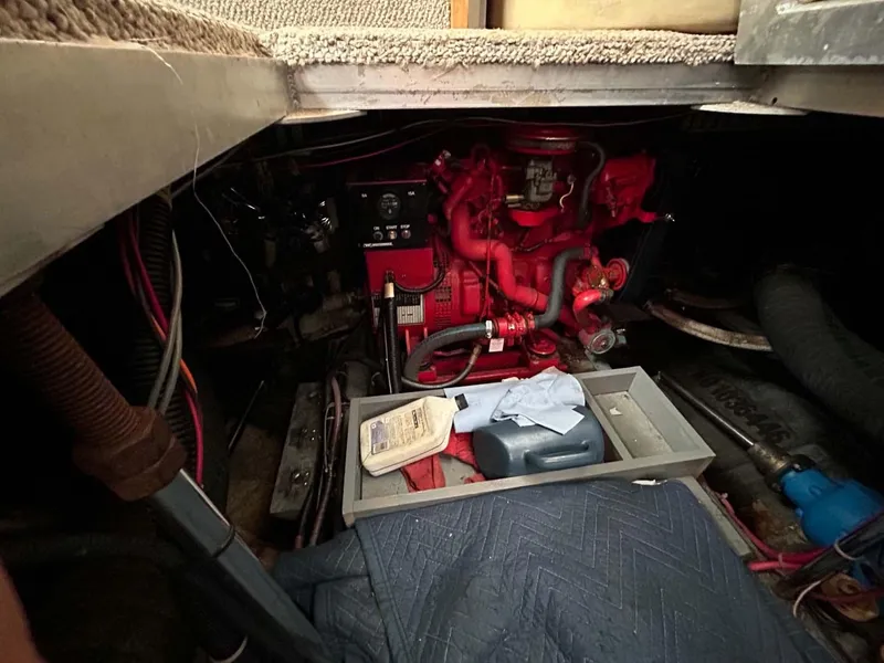 Slide: The Image of Engine compartment of a 1995 Carver 370 Aft Cabin with visible red engine components. - 26